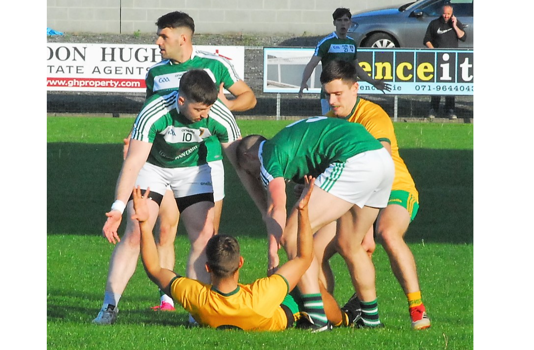 Shane Moran (on the ground) is tackled by two Mohill opponents on Friday evening Picture: Willie Donnellan