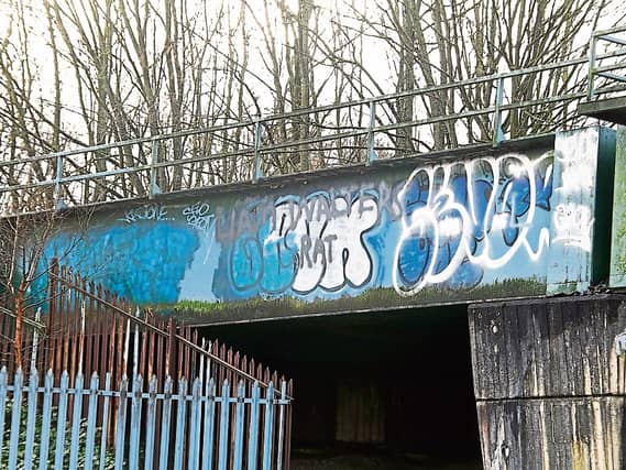 Grafitti has been sprayed on the railway bridge at Childers Road
