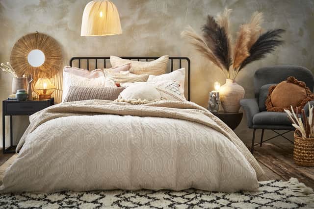 11. Abigail Ahern Set of 2 Large Taupe Faux Pampas Grass Stems, £24; Orson Monkey Table Lamp, £50; Pax Round Sand Cushion, £35, and Minka Voile Bedspread, £140 (other items from a selection), Freemans