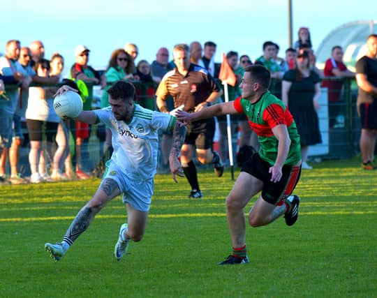 Craigbane’s Cahir O’Kane under pressure from Trasna’s Tomas McCrossan.