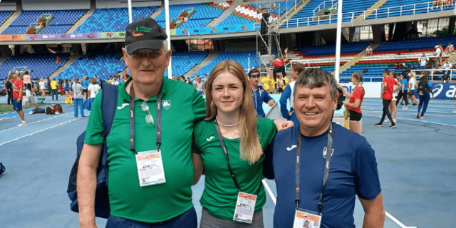 Lucy McGlynn with her coach Eamon Harvey and Finn Valley AC's Neil Martin, who is the Irish Team Leader in Colombia.