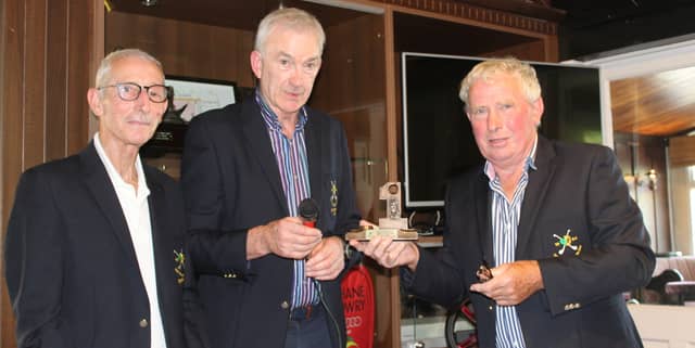 Johnny Flaherty, right, accepts a prize for his hole in one from All-Ireland Hurlers Golf Society captain Tom Donohue and secretary, Donie Collins, Cork.