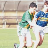 Kill Kevin Corrigan drives forward despite the chasing Oran Bergin Grange in the Top Cross JFC Round 1 game at Hawkfield. Photo: Sean Brilly
