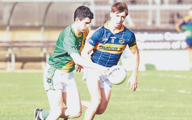 Kill Kevin Corrigan drives forward despite the chasing Oran Bergin Grange in the Top Cross JFC Round 1 game at Hawkfield. Photo: Sean Brilly