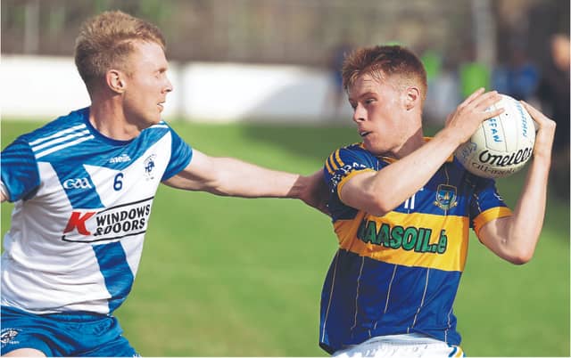 Fionn Bergin keeps tight hold of procession for Grangenolvin despite the close tackling of Straffan Ed Neenan in the EMS Copiers SFL Division 4 final at St Conleth's Park, Newbrige. Photo: Sean Brilly
