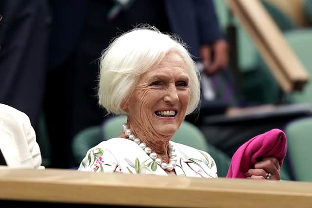 Dame Mary wore a pearl necklace with an elegant, bird-patterned white dress and bright pink jacket for the occasion.
