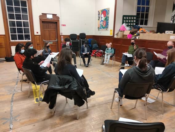 The cast busy at rehearsals
