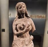 The goddess Isis with her baby son Horus at the breast (only his leg remains).