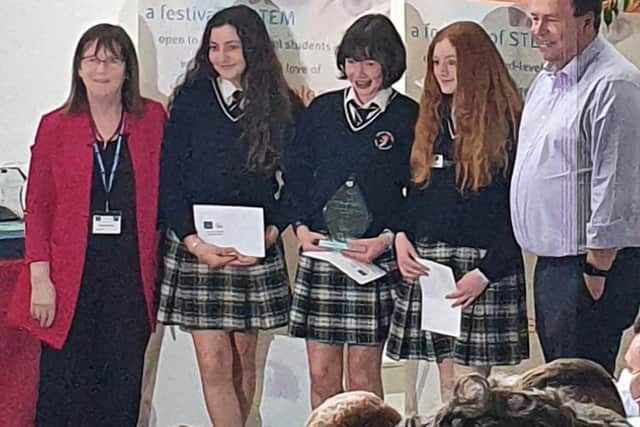 Below: Freya Ní Aoláin Rome, Caragh Ní Dhomhnaill, and Emma Ní Fhaoláin accepting their award