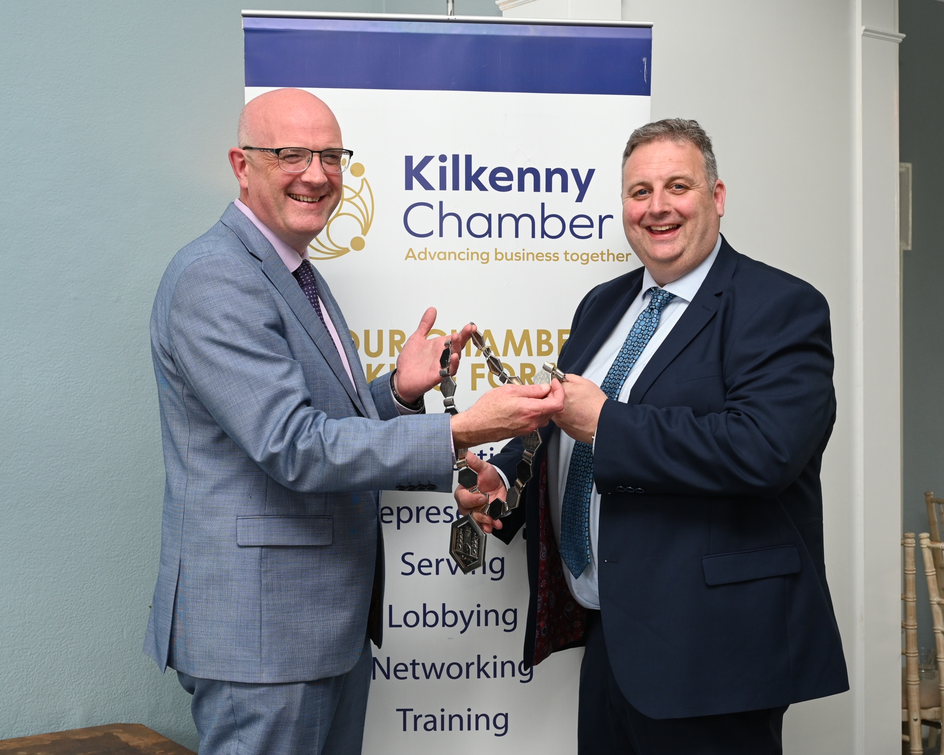Outgoing President of Kilkenny Chamber Colin Ahern hands over the Chain of Office to incoming President Brian Keyes Photo: Vicky Comerford