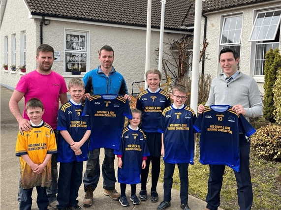 Martin and Stephen Grant, presenting a new set of jerseys to Ballylooby National School principal, Kieran Scanlon, which were kindly sponsored by Ned and Rita Grant, who have five grandchildren attend