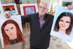 Adjudicator, Eoin Butler, holding two of the entries received from Co. Offaly this year both by pupils of Ballinamere NS