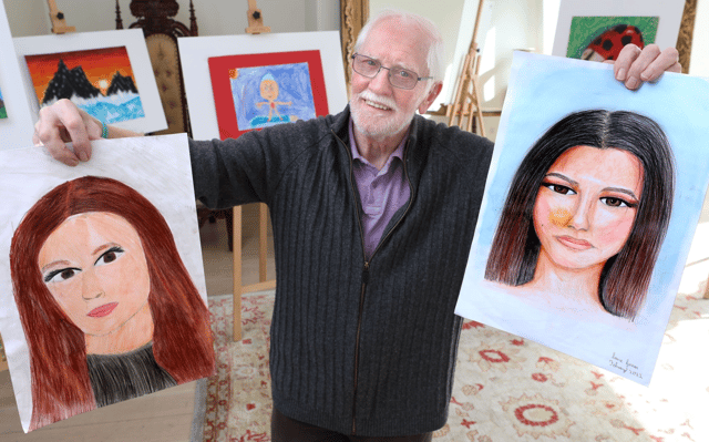 Adjudicator, Eoin Butler, holding two of the entries received from Co. Offaly this year both by pupils of Ballinamere NS