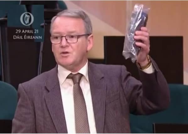Deputy Brian Stanley TD with a German peat briquette in Dáil Eireann