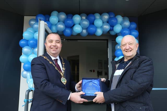 Mayor Brian Tierney makes a presentation to Tommy McCourt to mark his retirement.