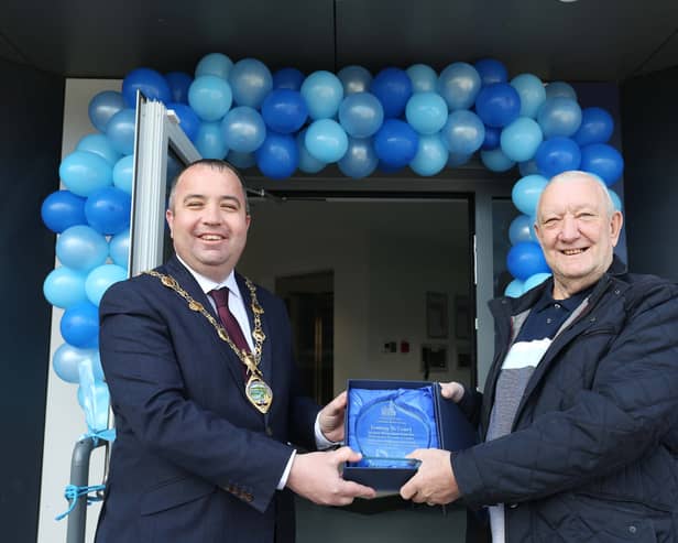 Mayor Brian Tierney makes a presentation to Tommy McCourt to mark his retirement.