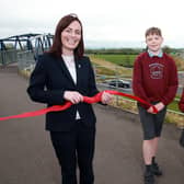 Nichola Mallon cuts the ribbon on the new road section.