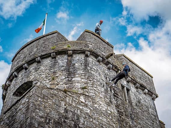 Eoin Barry, Askeaton, abseiling down the side of King John's Castle under the guidance of Dave Neville, Nevsail ahead of its re-opening next week