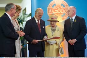 May 2011: The Duke of Edinburgh examines a hurley and sliotar presented to him by GAA President Christy Cooney in the presence of President Mary McAleese, Dr Martin McAleese and HM Queen Elizabeth II