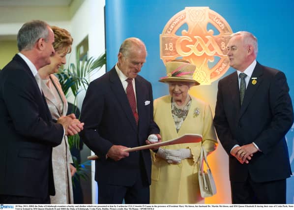 May 2011: The Duke of Edinburgh examines a hurley and sliotar presented to him by GAA President Christy Cooney in the presence of President Mary McAleese, Dr Martin McAleese and HM Queen Elizabeth II