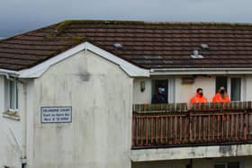 PSNI and Police Ombudsman officials pictured today at the scene of last night's shooting.