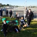Staff and members of Long Tower Youth Club bury the time capsule in the local park.