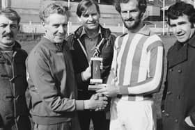 Terryy Kelly pictured receiving a trophy during his career.