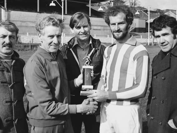 Terryy Kelly pictured receiving a trophy during his career.