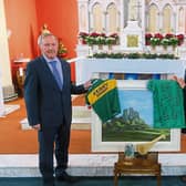 Joe Lyons and his successor Sheila Hayes, with a gift of a signed Limerick GAA jersey, a Kerry jersey, and a picture by local artist Jim O’Farrell