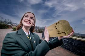 Jeannie McLaughlin, the Head Girl of St Cecilia's College in Derry, shows off the award which the school has received after securing the title of Secondary School of the Year.