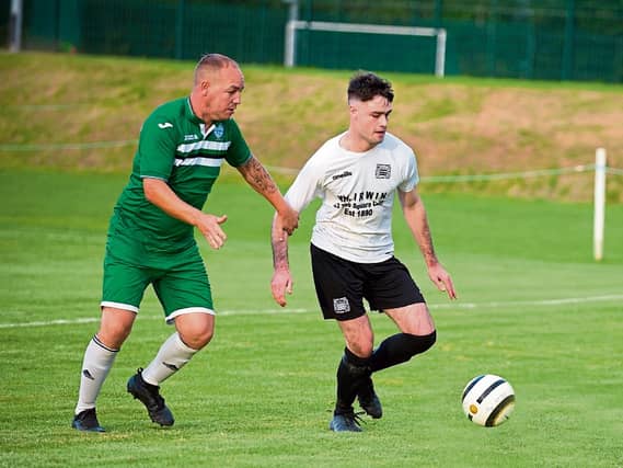 Conor Lonergan feels the presence of Clonmel Celtic’s Shane Butler in the Tipperary Cup semi-final in Clonmel