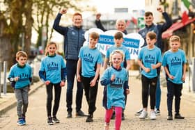 Limerick hurling boss John Kiely with players Will O'Donoguhe and Diarmaid Byrnes launch the fun run with a little help from young athletes