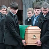 Sad farewell: The Ahane GAA flag was draped over Willie Keane’s coffin as he went to his eternal reward after a life well-lived  - PICTURE: Dave Gaynor