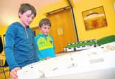 Coleman Dunne (12) and Oisin Maher (8) inspect a model of the  proposed development at Danesfort GAA club’s grounds