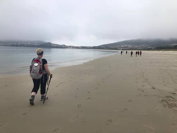 Martine Rigney completing the final stretch along the beach at Finisterre, the official end of her camino walk