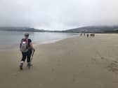 Martine Rigney completing the final stretch along the beach at Finisterre, the official end of her camino walk