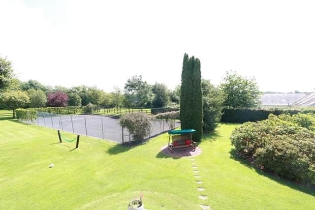 Outside the property benefits from a spacious tarmacadam driveway with ample parking for several cars. The property sits on c. 2.75 acres of land and boasts stunning landscaped manicured gardens, a full-size tennis court which will delight tennis fans, four outbuildings which can be used for a variety of purposes, a feature sandstone patio and walkway, stud rail fencing, wrap around drive way and much more.