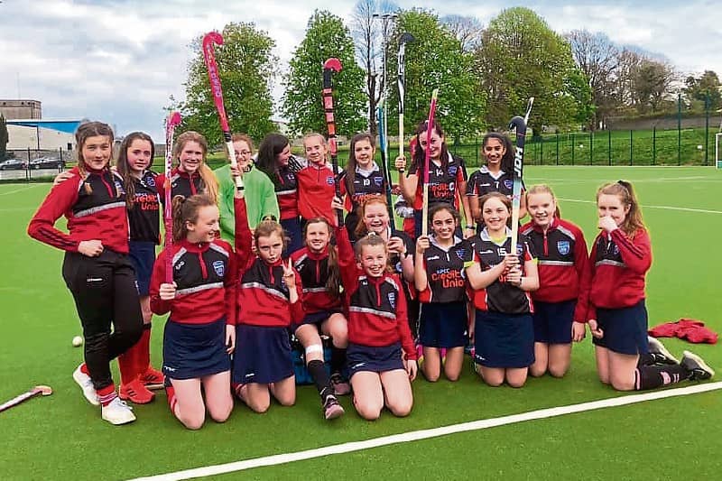 Members of the school's girls hockey team celebrating a win