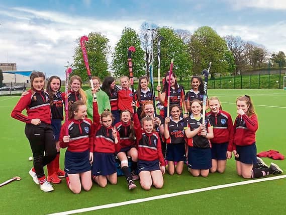 Members of the school's girls hockey team celebrating a win