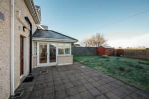 Meanwhile, to the rear of the property there is a large back garden in lawn with a patio area. There are also two side entrances for easy access to the property and its lovely gardens.
