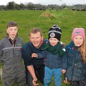 Green, green grass of home: John Macnamara with Pádraic, Ailbhe and Conor on their Knockainey farm which hosts an open day next Wednesday Picture: Michael Cowhey