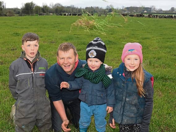 Green, green grass of home: John Macnamara with Pádraic, Ailbhe and Conor on their Knockainey farm which hosts an open day next Wednesday Picture: Michael Cowhey