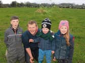 Green, green grass of home: John Macnamara with Pádraic, Ailbhe and Conor on their Knockainey farm which hosts an open day next Wednesday Picture: Michael Cowhey