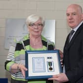 Sheila Stack is presented with Brian Stack's 21 Year Medal by Director General Michael Donnellan at the memorial service for Brian Stack at the Prison Service College, Portlaoise. Picture: Alf Harvey/