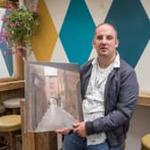 Artist Rob Norwood pictured with one of his paintings