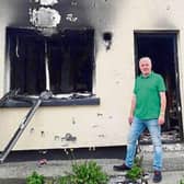 Cllr John Costelloe pictured outside one of the houses which was targeted