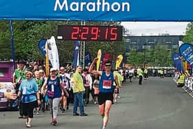 A delighted Colin Griffin raises his arm as he crosses the line in fifth place in Monday's Belfast City Marathon. Photo by Ryan Maxwell