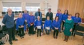 Member of the Cairdeas Choir pictured with Ann Moylan