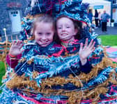 Two youngsters enjoying  the fashion show in the Castle Yard by the Design and Crafts Council  of Ireland as part of Culture Night