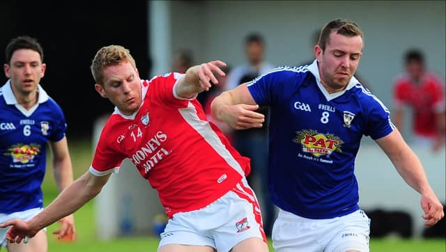 Ballymahon's Colm Flynn in a tussle with St Mary's Granard opponent Charlie Martin in the Senior Football Championship Group 3 second round clash last weekend. Photo: Declan Gilmore